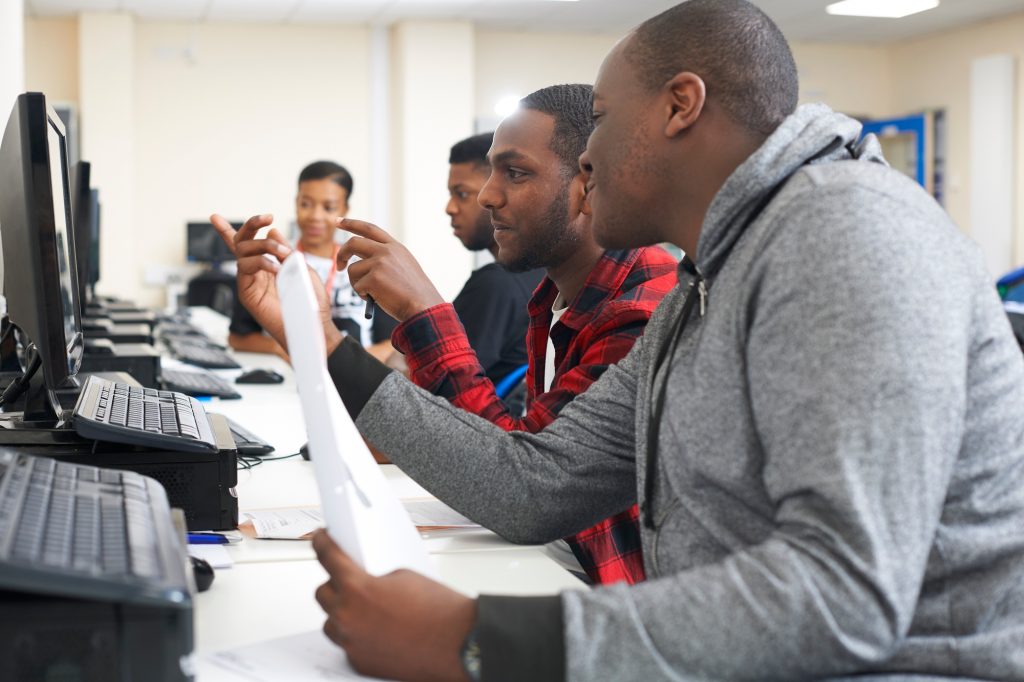College students studying with computer in classroom